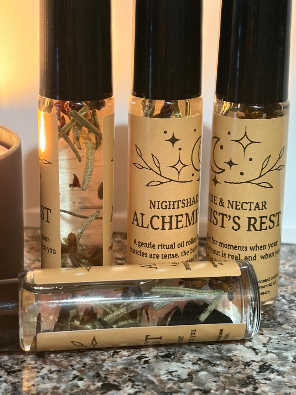 Three small bottles with labels on a countertop